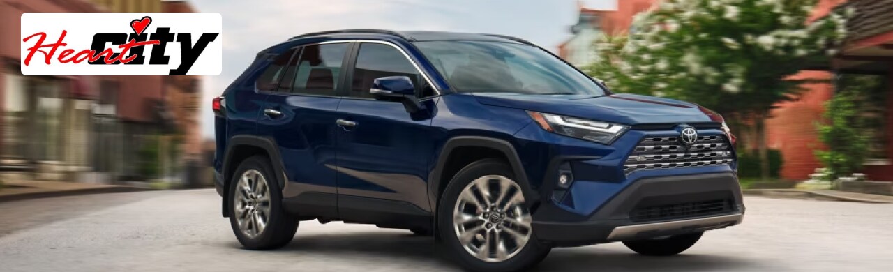Toyota-RAV4-Adventure-Awaits-with-This-Versatile-SUV1.png Heart City Toyota dealership showcasing a lineup of Toyota RAV4 SUVs in Elkhart, IN.