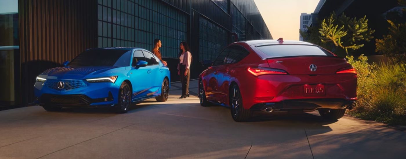 Red and Blue 2026 Acura Integra parked outside a building.