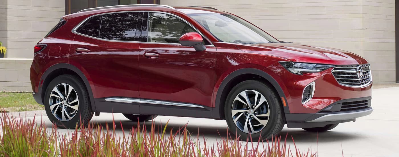 Red 2026 Buick Envision parked on a driveway.