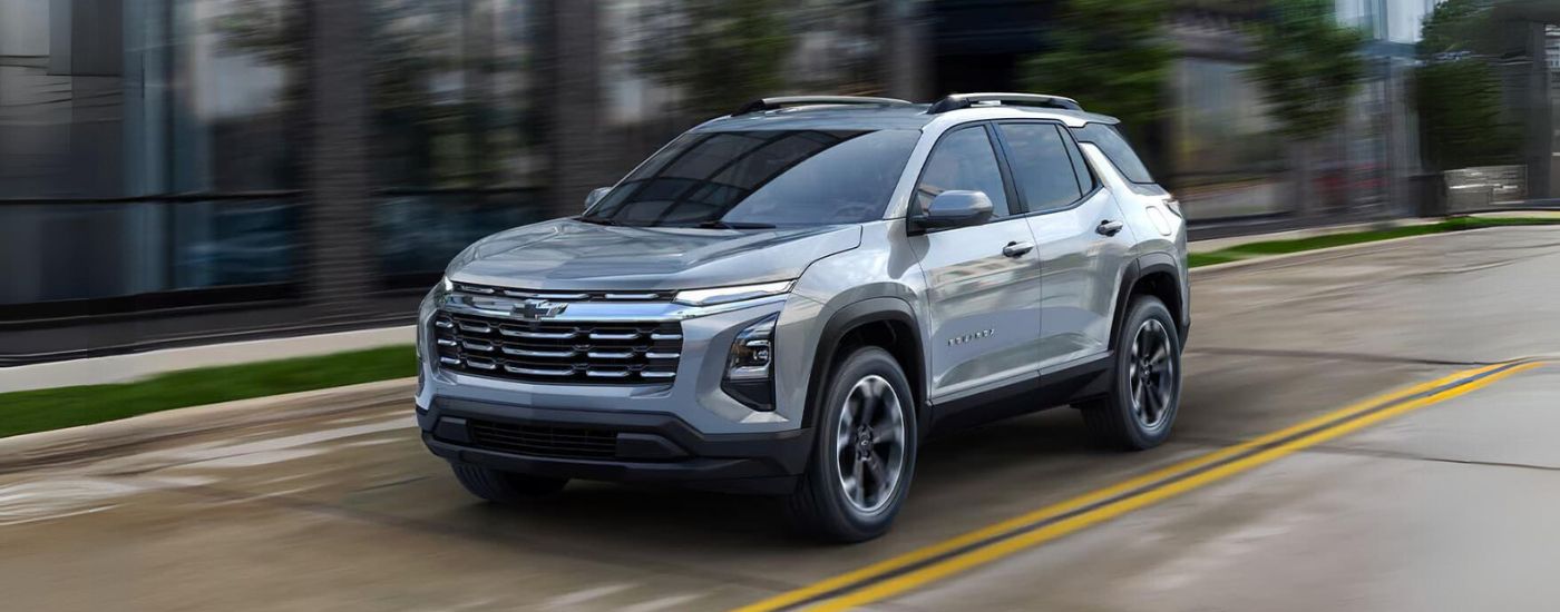 2025%20Chevy%20Equinox%20-%20Blur.jpg Silver 2025 Chevy Equinox driving through a city