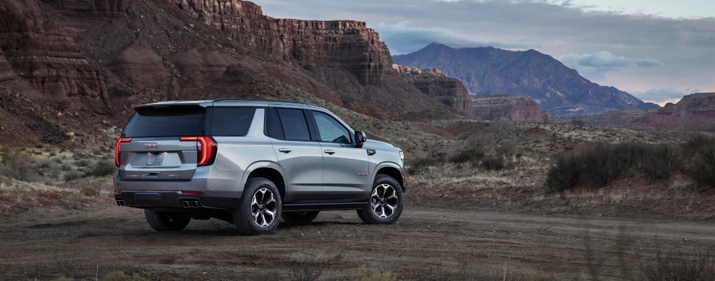 A silver 2025 GMC Yukon from the side.