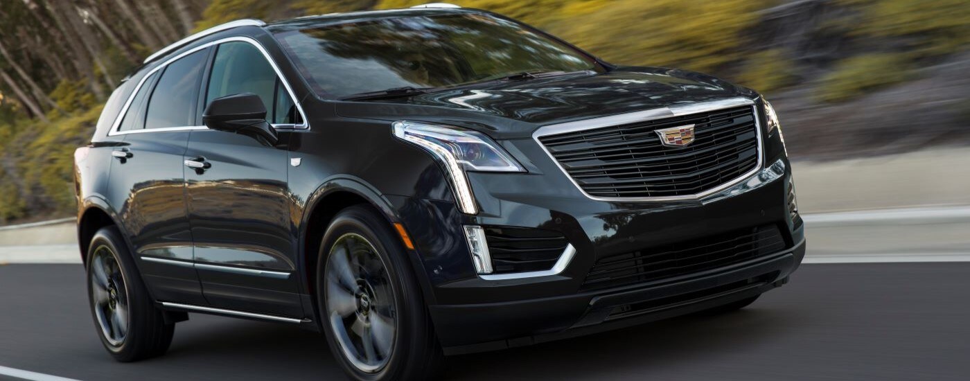 Black 2019 Cadillac XT5 driving down an open road.