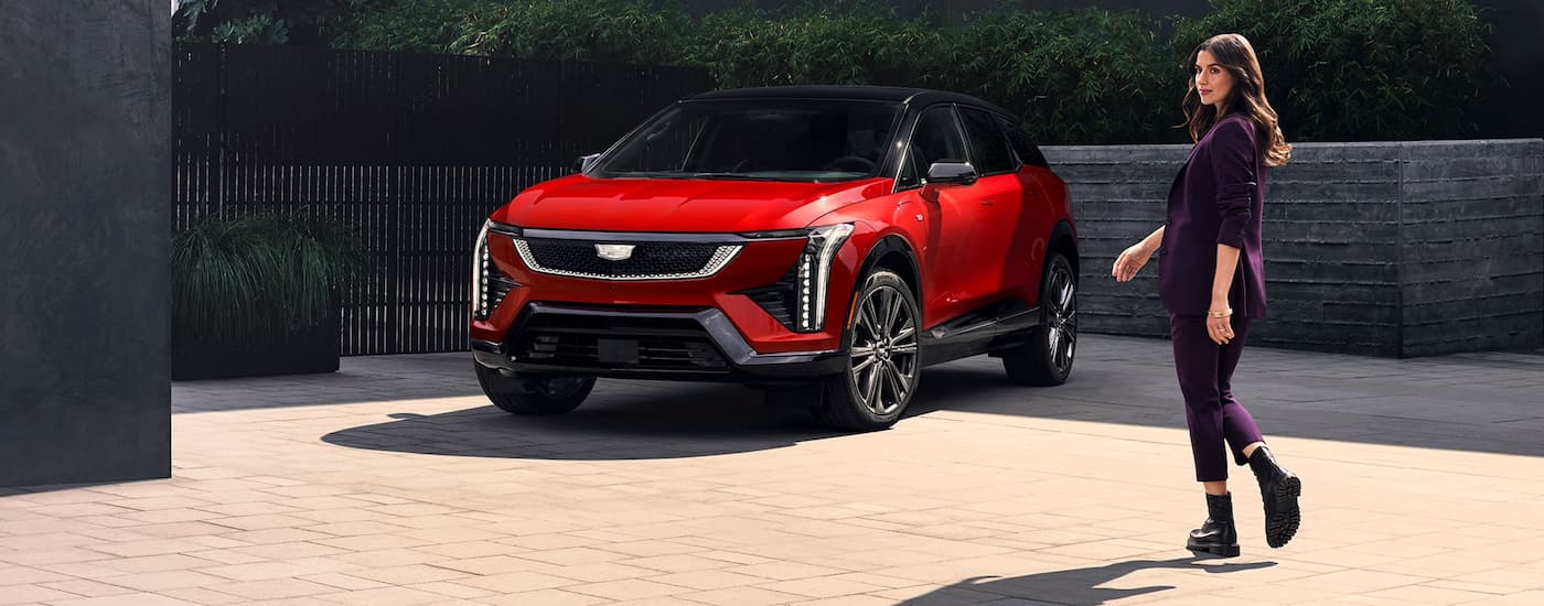 Red 2026 Cadillac OPTIQ-V parked on a driveway.