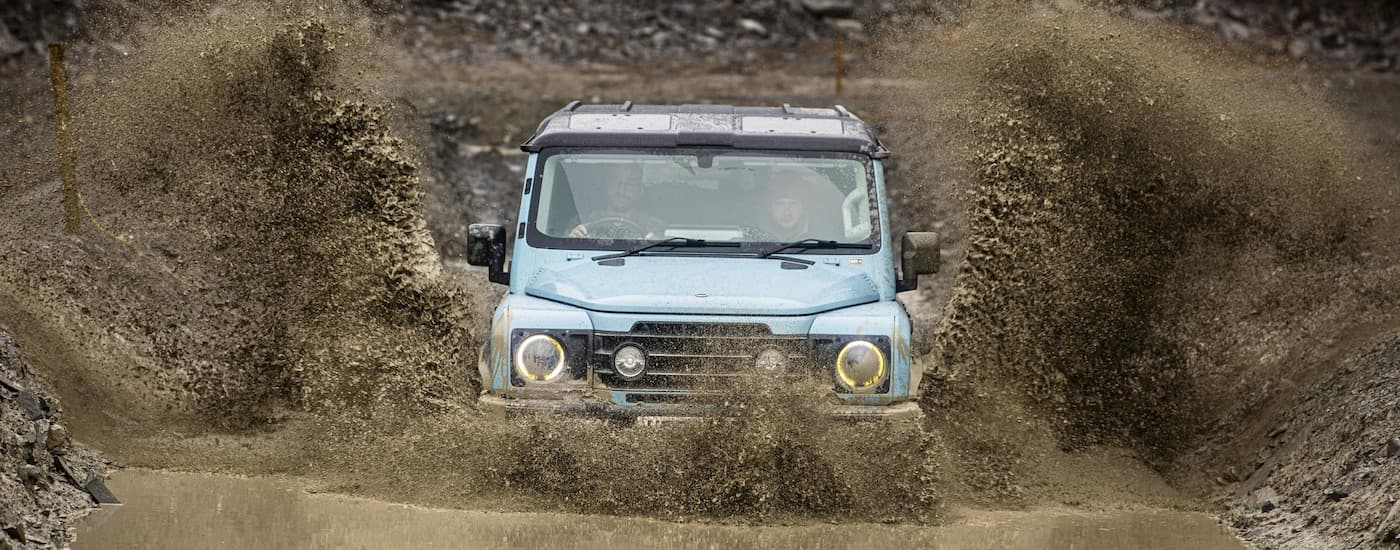 wlp - 2026 INEOS Grenadier for Sale Near Columbia - Mud.jpg A blue 2026 INEOS Grenadier off-roading in mud