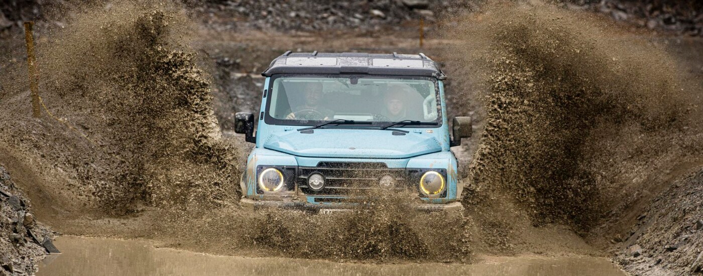 Ineos%20Grenadier%20-%20mud.png Mint 2026 INEOS Grenadier driving through a muddy puddle