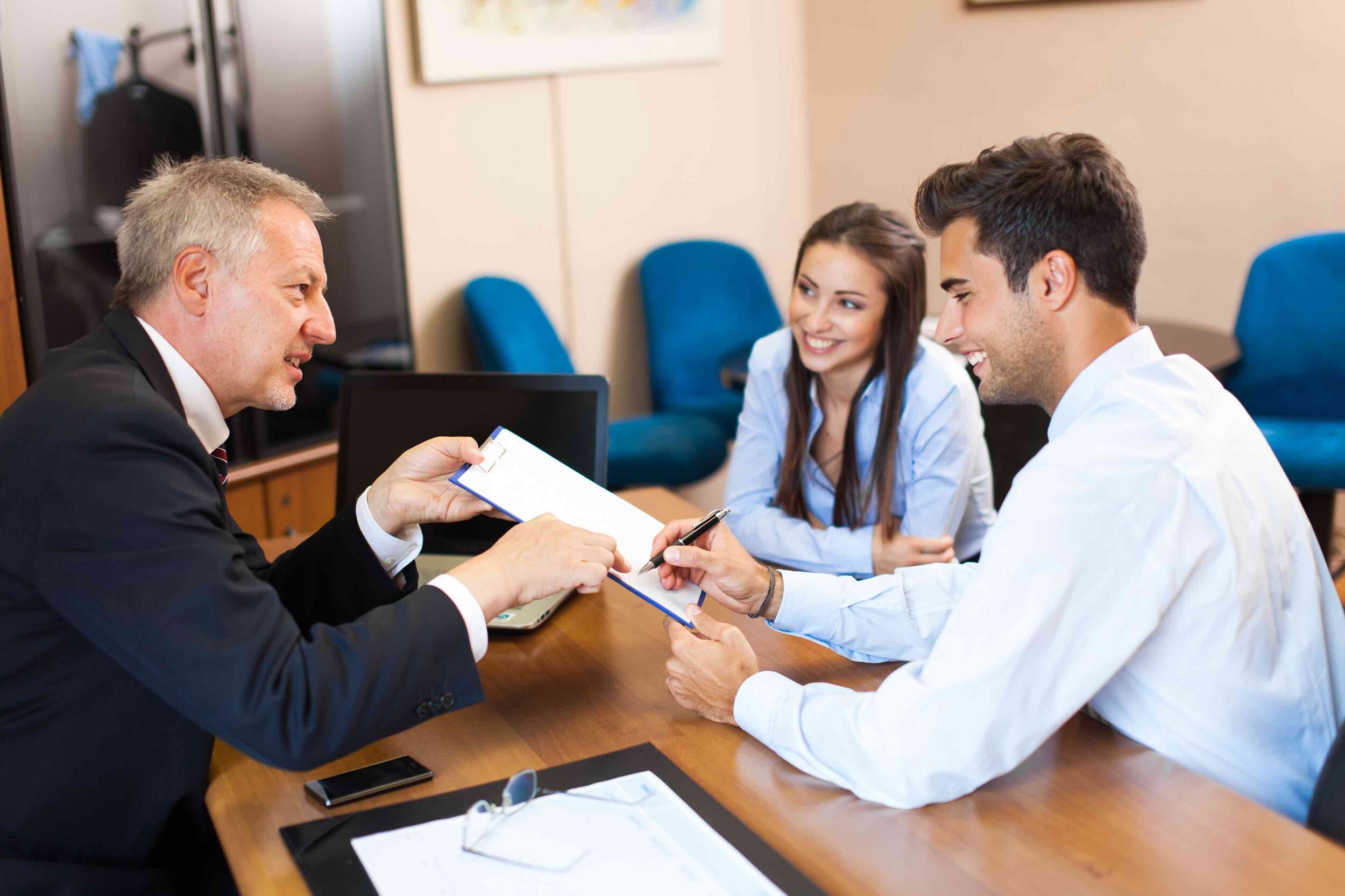 Businessman showing document to a couple_LARGE.jpeg