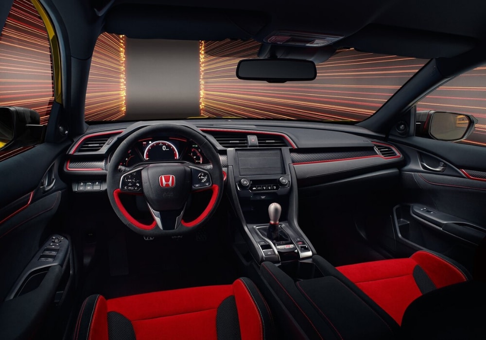 Front interior design inside the upcoming 2021 Honda Civic Type R 
showing Type R-accented trims and red-black colors