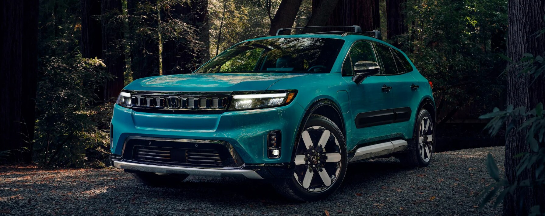 Screenshot%202025-03-18%20203819.png Blue Honda Prologue parked in the woods.