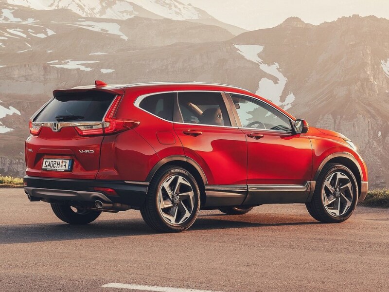 Back side Exterior of a red 2019 Honda CR-V parked in an opening at the base of a snowy mountain