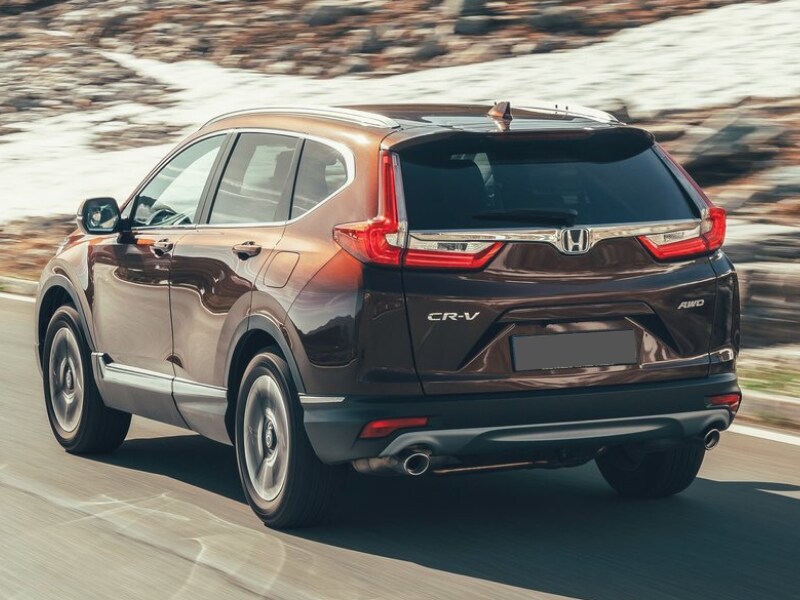 Rear exterior view of a 2019 Honda CR-V driving down a mountain road