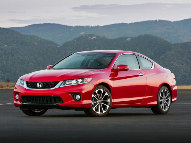 Honda Accord Coupe Driver side angle of a red Honda Accord coupe parked on asphalt with a mountain range in the background