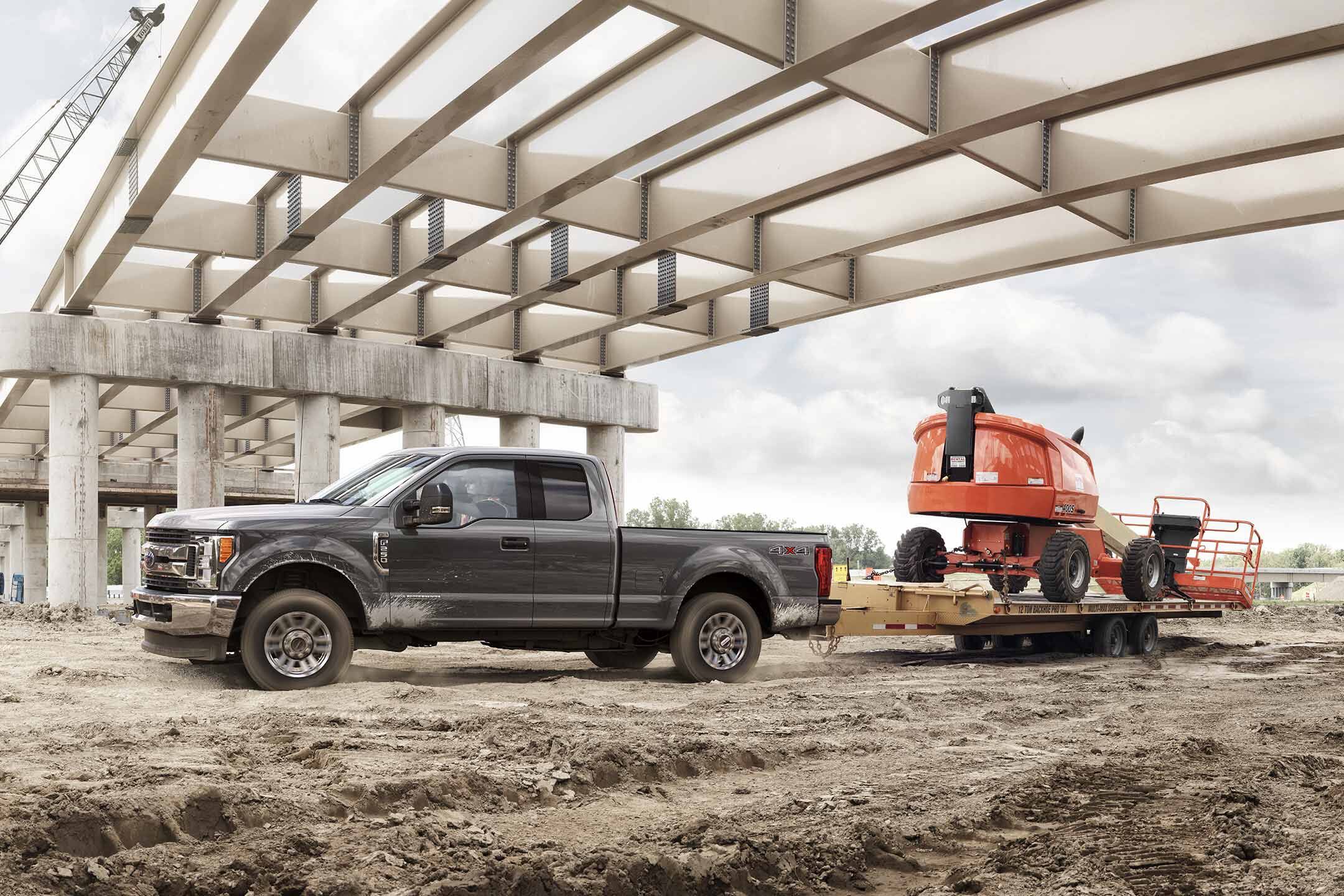 Ford F-250 Towing Under A Bridge On a Construction Site