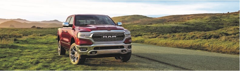 Red Ram 1500 front view in green field