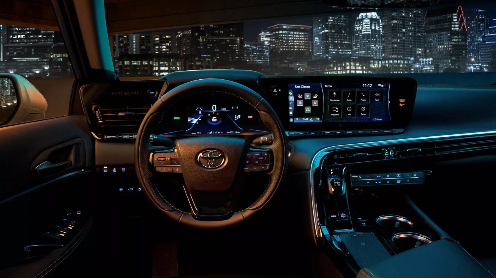 2022-Toyota-Mirai-4.PNG A view of the all black dash of a 2022 Toyota Mirai with a view of the city beyond