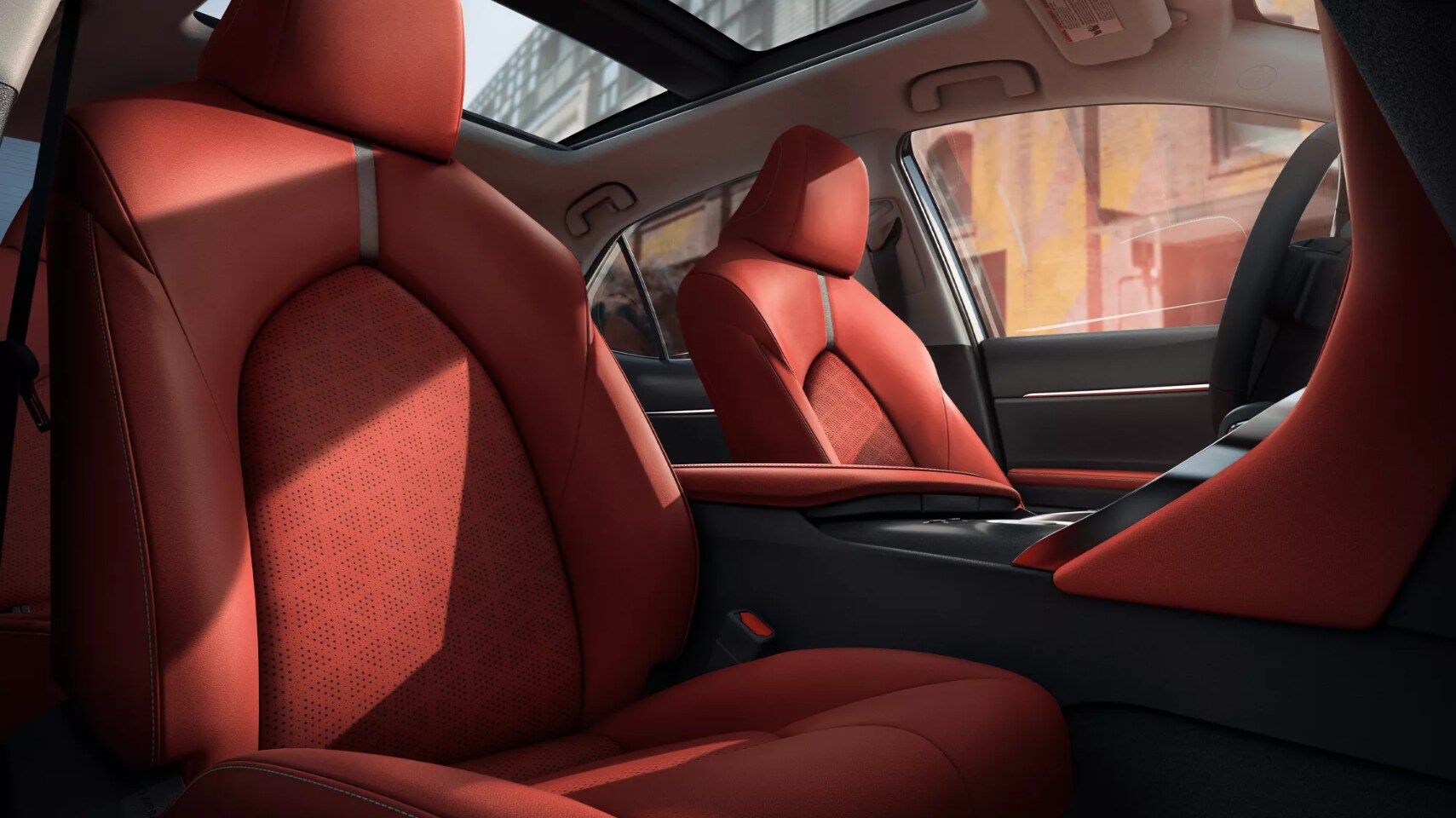 2022-Toyota-Camry-Hybrid-5.PNG A view of the seating and cabin of a 2022 Toyota Camry Hybrid with red upholstery and a sunroof