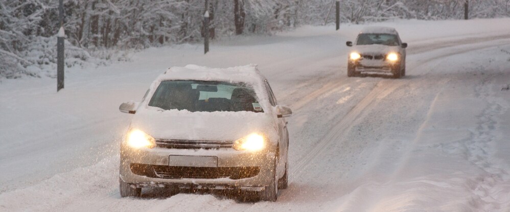 Cars driving on plowed snowy road in winter.jpg