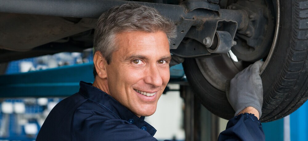 Mechanic In Workshop Changing Tire.jpg