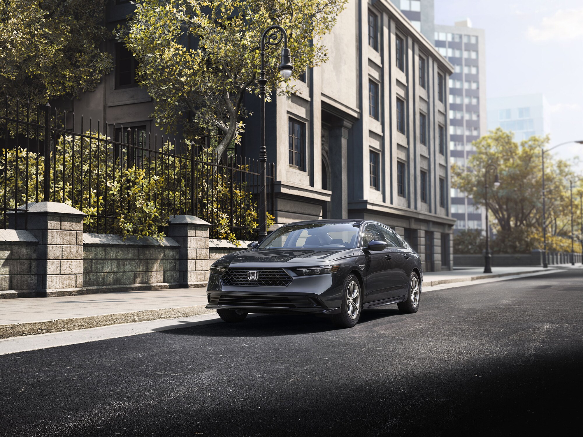 dark grey Honda Accord parked in front of a stone and wrought iron wall