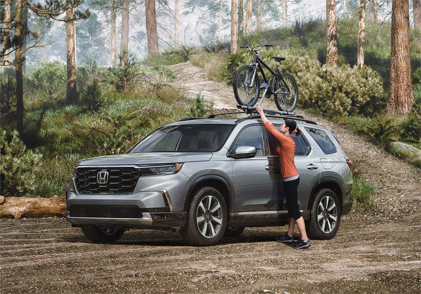 grey Honda Pilot parked with the driver taking a bike off the roof rack
