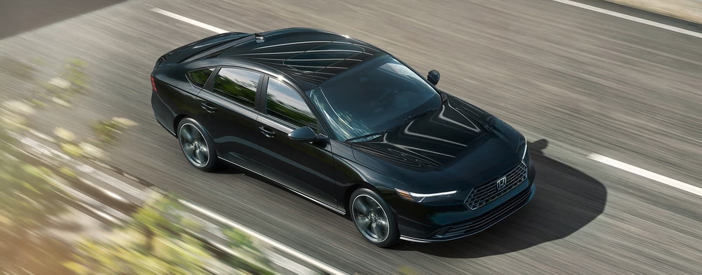 2026 Honda Accord Black Driving.jpg Black 2026 Honda Accord driving on a highway