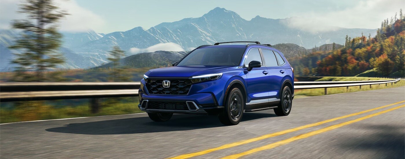 A blue 2025 Honda CR-V Hybrid for sale from the front at an angle.