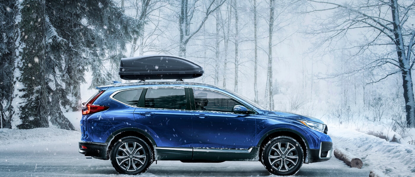 2020 Honda CR-V in Blue parked in snowy parking lot in the forest