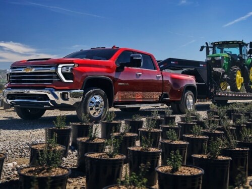2025 Chevrolet Silverado HD towing a tractor
