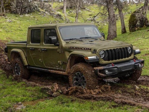 2025 Jeep Gladiator offroading through muddy terrain