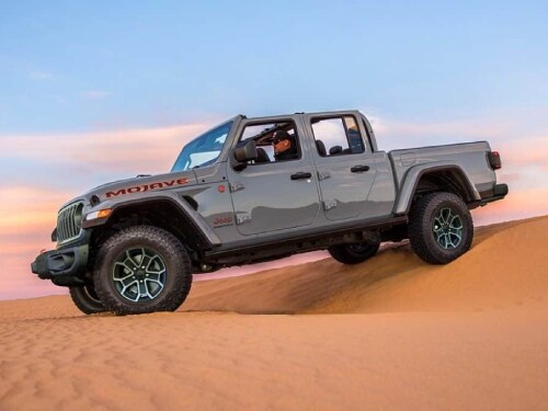 2025 Jeep Gladiator driving over sand dunes