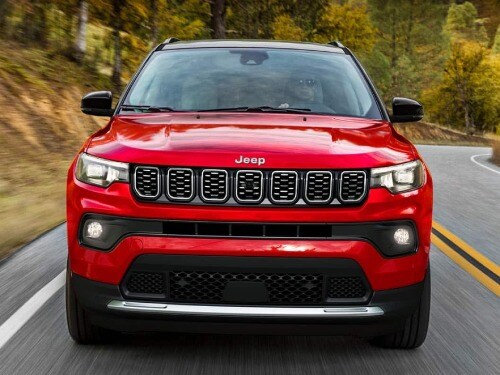 2026 Jeep Compass frontal view, driving on a highway
