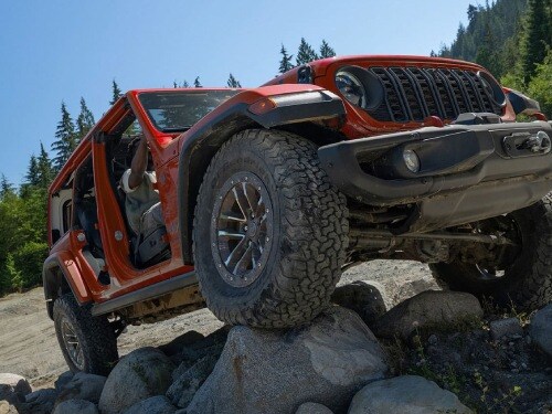 2026 Jeep Wrangler offroading over large rocks