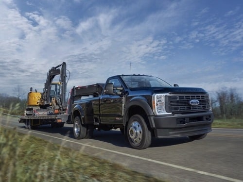 2025 Ford Super Duty towing a tractor
