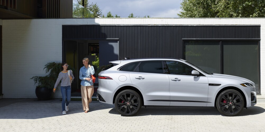 SILVER JAGUAR F-PACE PARKED IN DRIVEWAY.