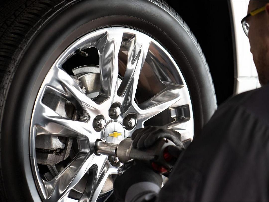 ia_11300000065.jpg Chevrolet technician rotating tires in Lewisville, TX