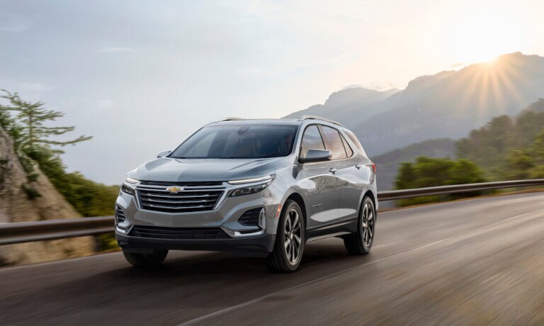 2024 Chevy Equinox driving through sunny hills