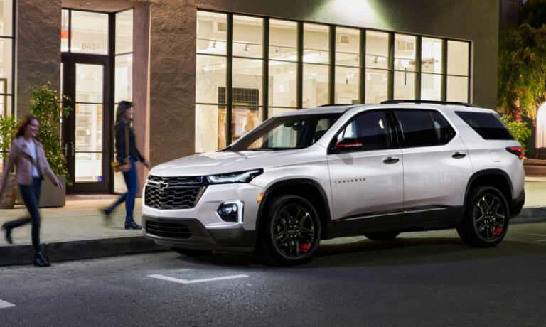 2023 Chevy Traverse parked outside a shop at night