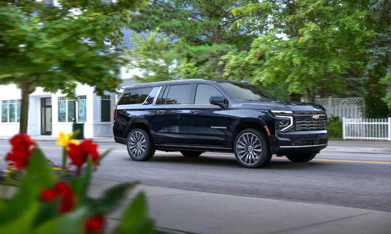 2025 Chevy Suburban driving in a neighborhood