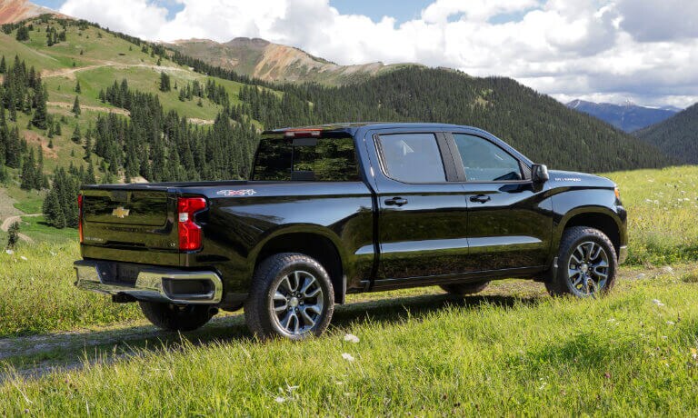 2025 Chevrolet Silverado 1500 driving in a grassy field