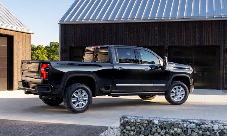 2025 Chevy Silverado 2500 HD parked by a barn