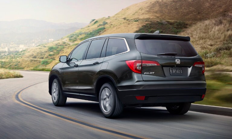 2022 Honda Pilot driving fast down a curving road