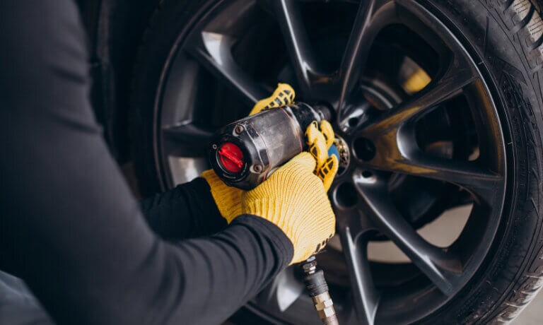 Technician replacing a car tire