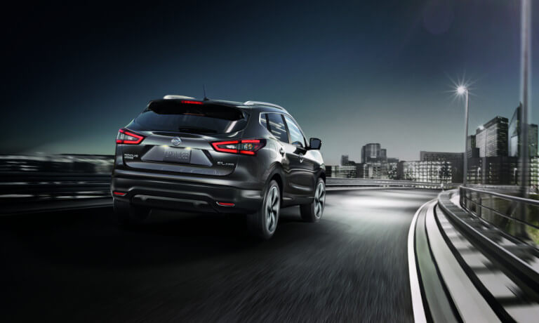2022 Nissan Rogue Sport driving away in the city at night
