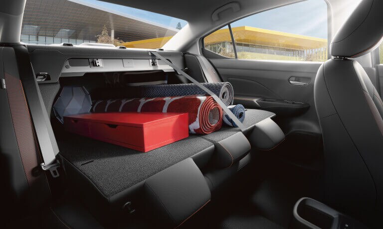 2022 Nissan Versa interior seats folded down with rugs