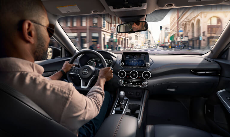 Man driving a 2022 Nissan Sentra in the city