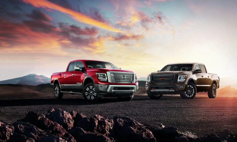 Two 2022 Nissan TITANs parked side-by-side at sunset