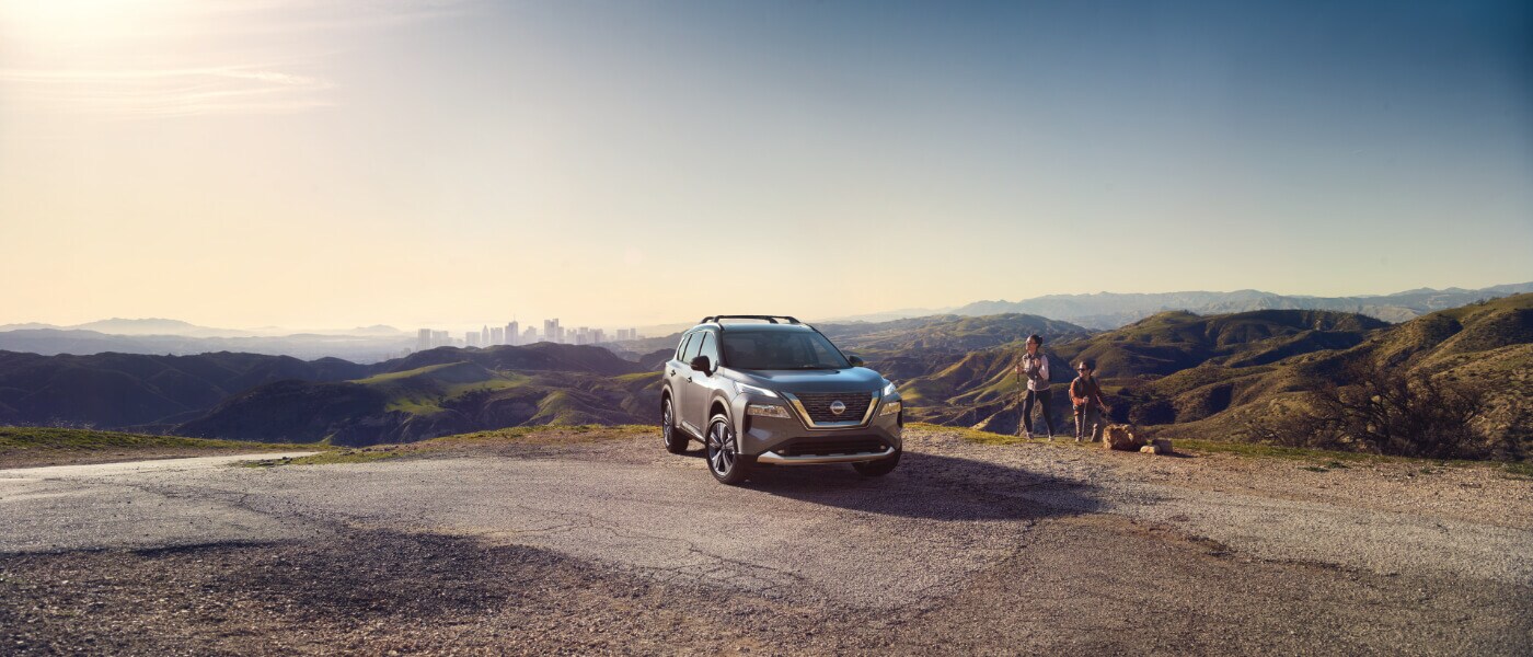 2025 Nissan Rogue parked in mountains with hikers