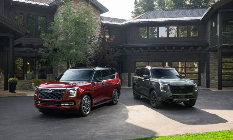 Two 2025 Nissan Armada SUVs parked in front of house