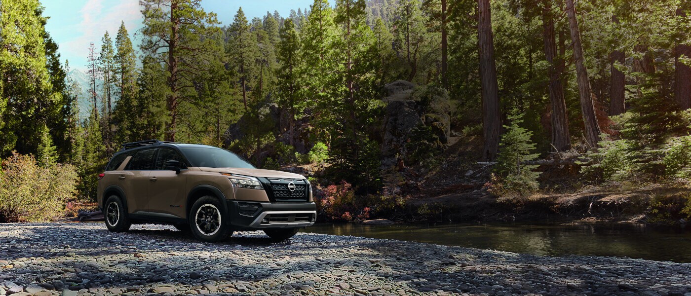 2025 Nissan Pathfinder parked by rocky creek