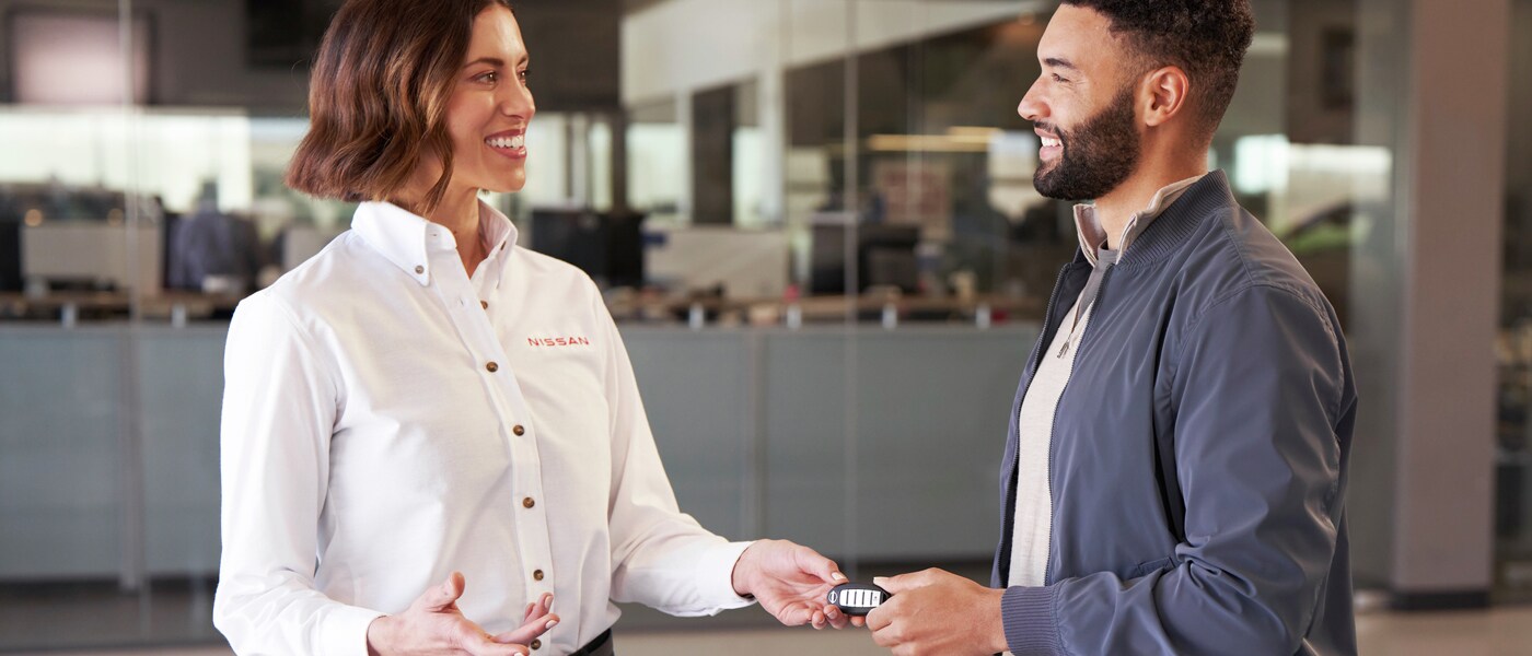 Employee and customer exchanging keys