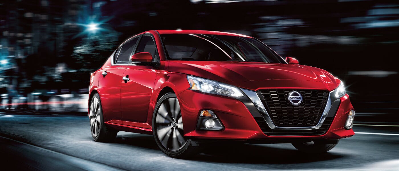 2025 Nissan Altima driving on a highway at night